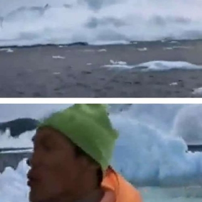 Iceberg gigante quebra causando ondas imensas que quase atinge um pequeno barco